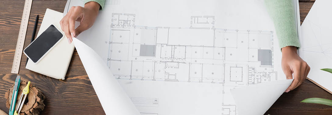 cropped view of african american architect near blueprint and smartphone with blank screen, banner